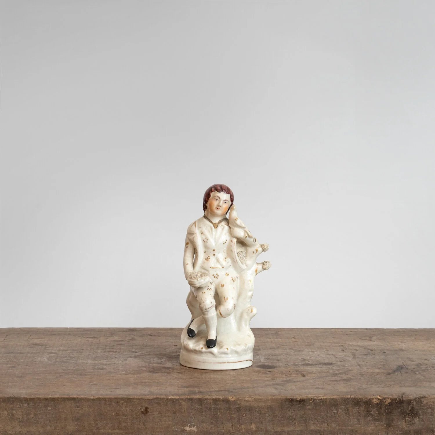 STAFFORDSHIRE FIGURINE OF A BOY WITH BIRD
