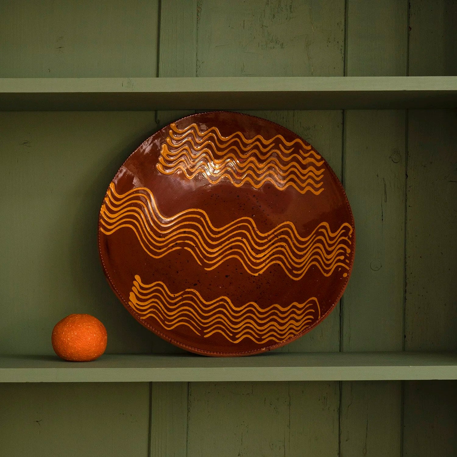 REDWARE PLATE WITH STYLIZED WAVE PATTERN