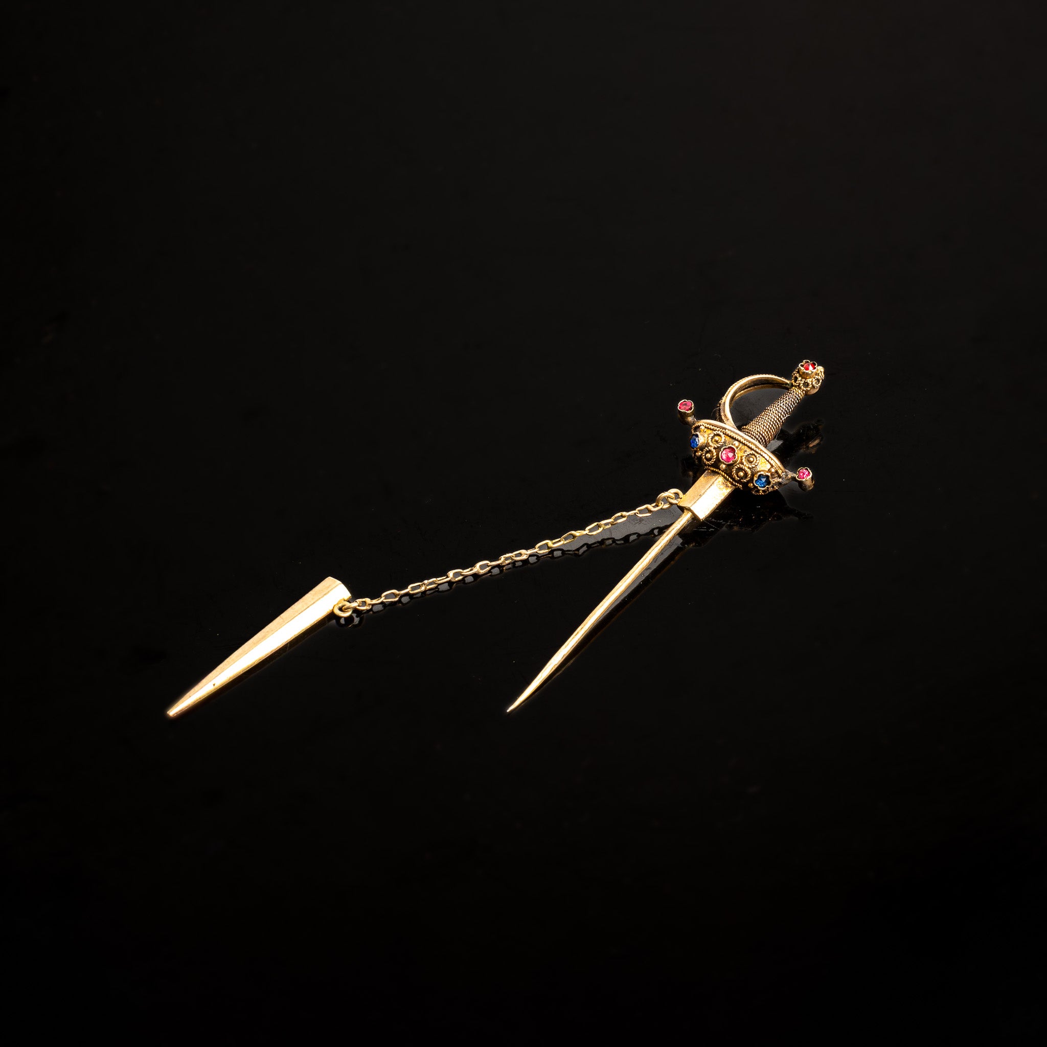 LATE 19TH-CENTURY GOLD SWORD JABOT PIN WITH RUBY AND SAPPHIRE ACCENTS