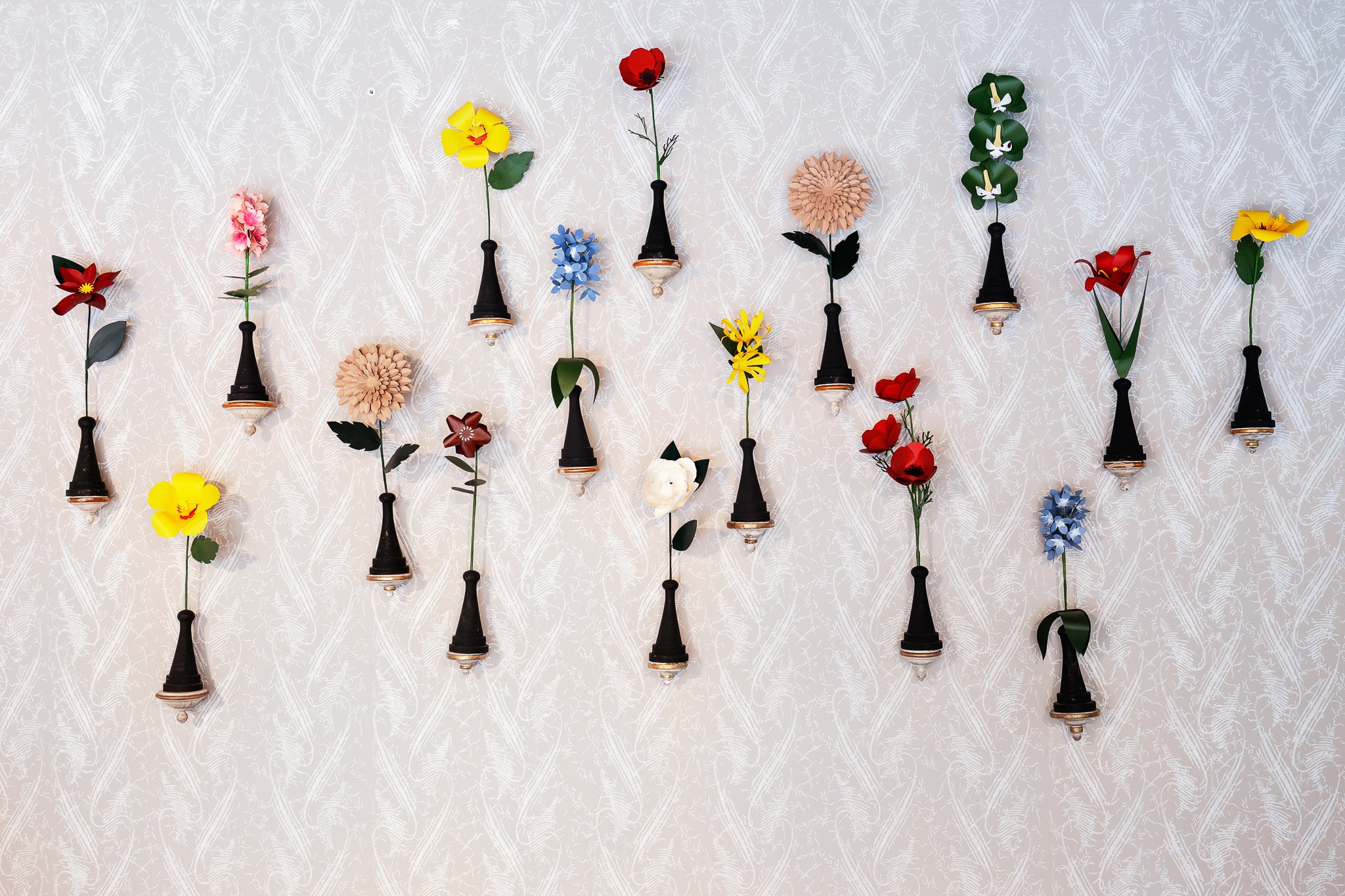 COLLECTION OF SIXTEEN 18TH-CENTURY ANTIQUE WALL BRACKETS WITH PAPER FLOWERS ON HAND TURNED WOOD BASES