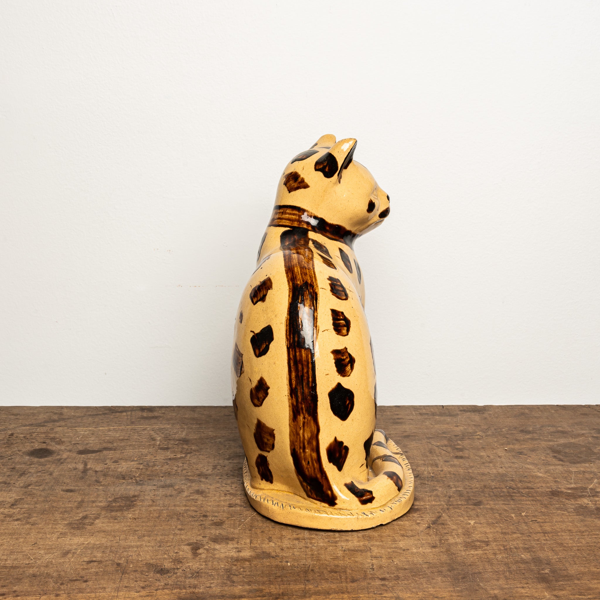 LATE 19TH-CENTURY ENGLISH STAFFORDSHIRE-STYLE GLAZED EARTHENWARE LEOPARD CAT FIGURE