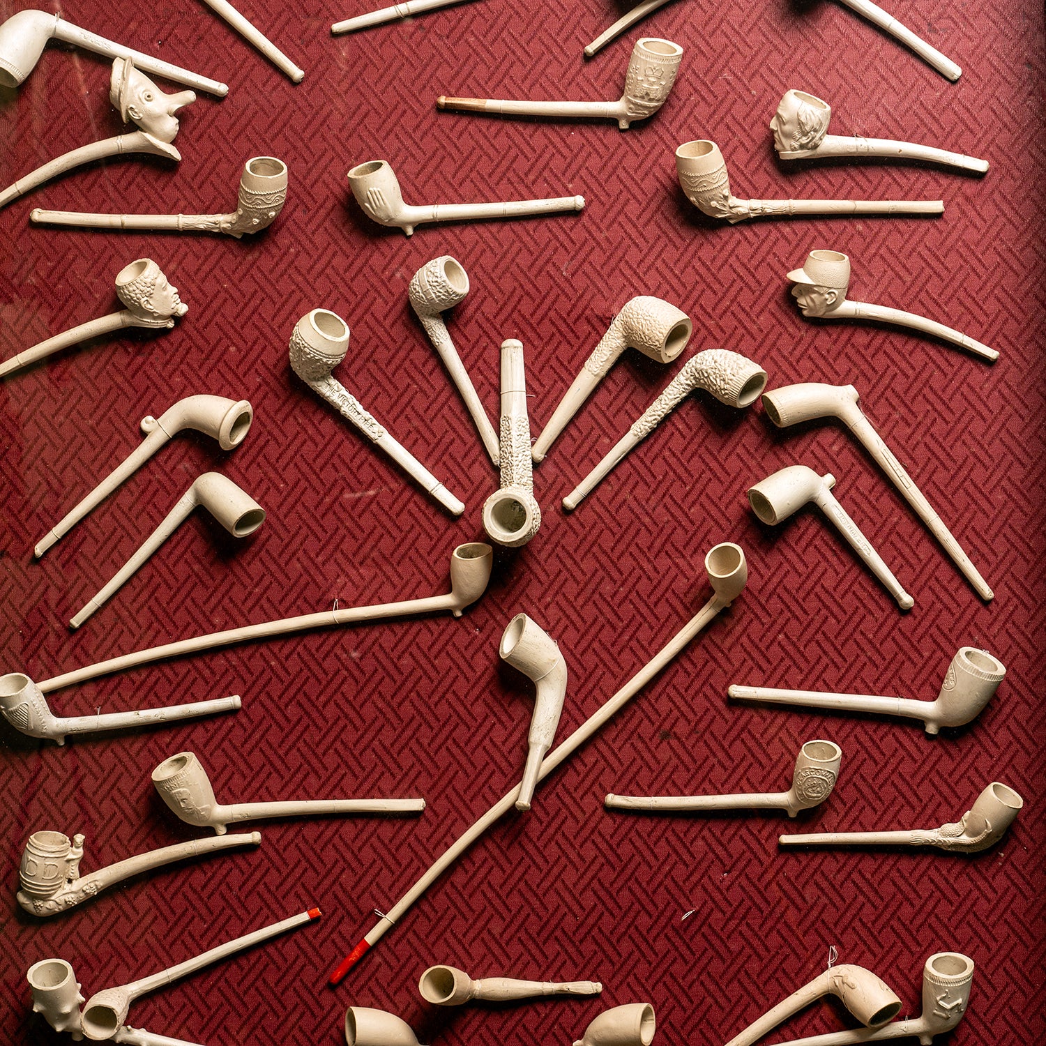 COLLECTION OF 18TH & 19TH-CENTURY CLAY PIPES IN A GLASS FRONT PRESENTATION CABINET
