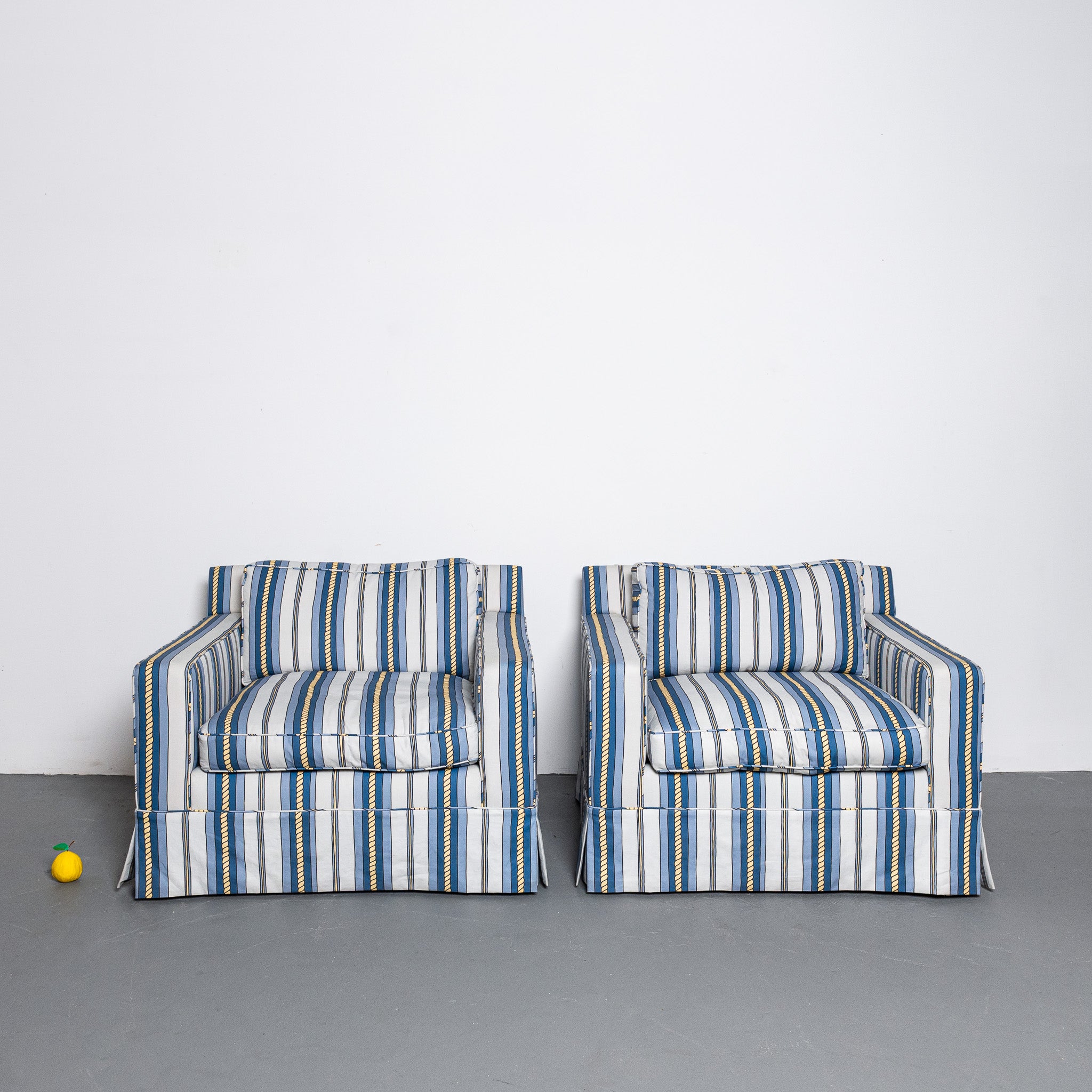 Pair of mid-century American club chairs newly upholstered in DNR Ropes and Strioes fabric