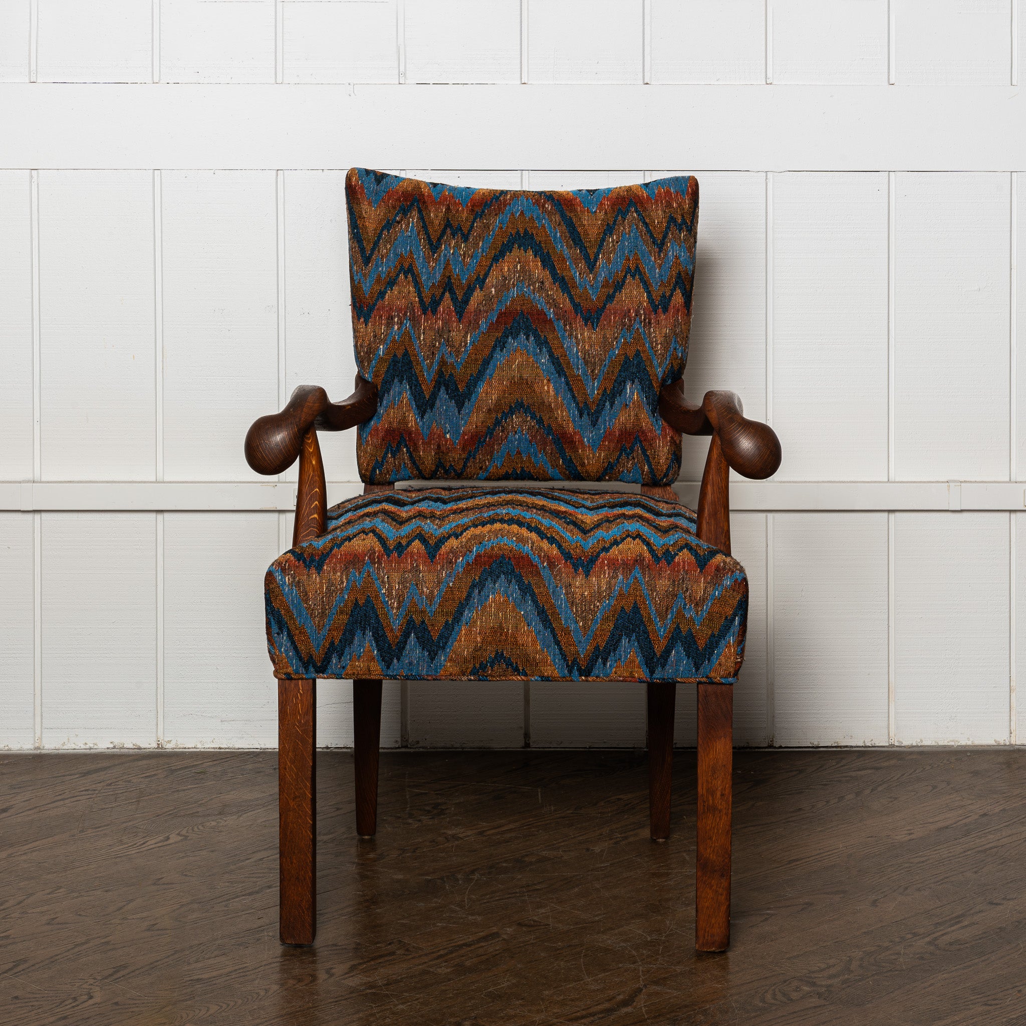 Early 20th century carved German armchair newly upholstered in a vintage flamestich fabrci
