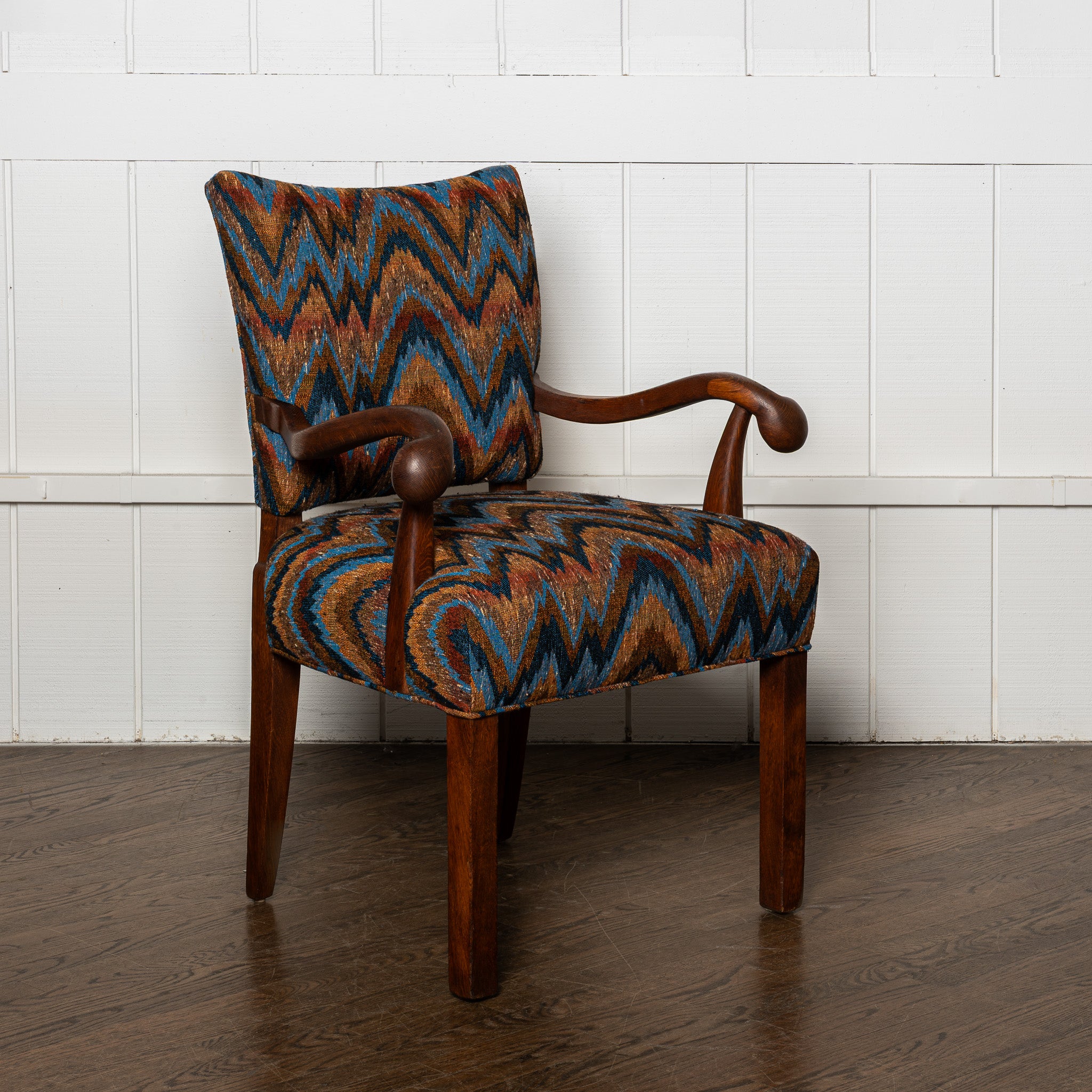 Early 20th century carved German armchair newly upholstered in a vintage flamestich fabrci