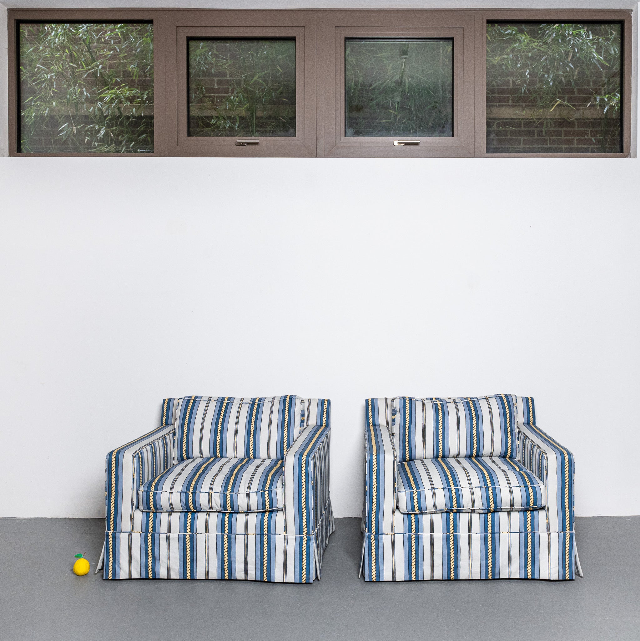 Pair of mid-century American club chairs newly upholstered in DNR Ropes and Strioes fabric