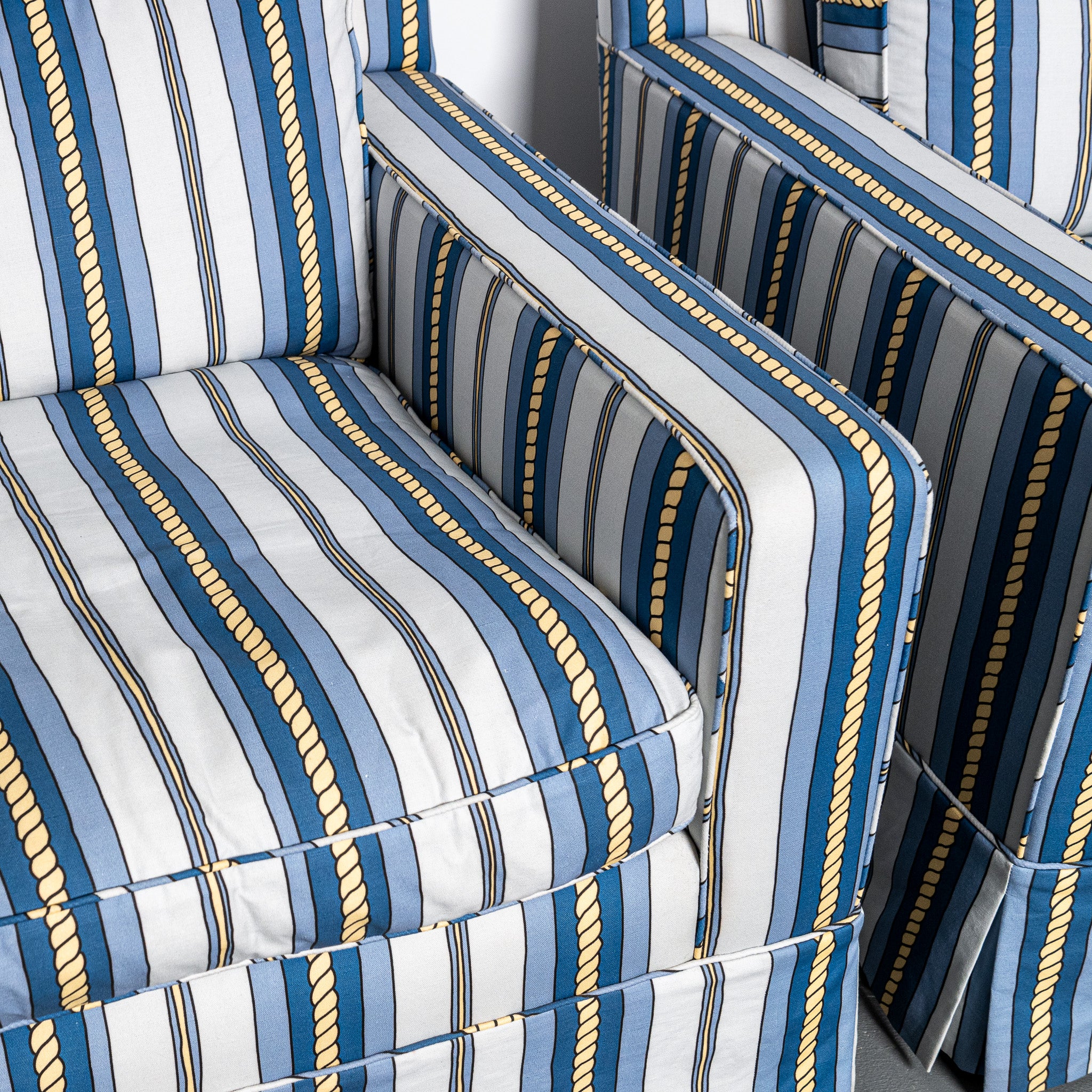 Pair of mid-century American club chairs newly upholstered in DNR Ropes and Strioes fabric