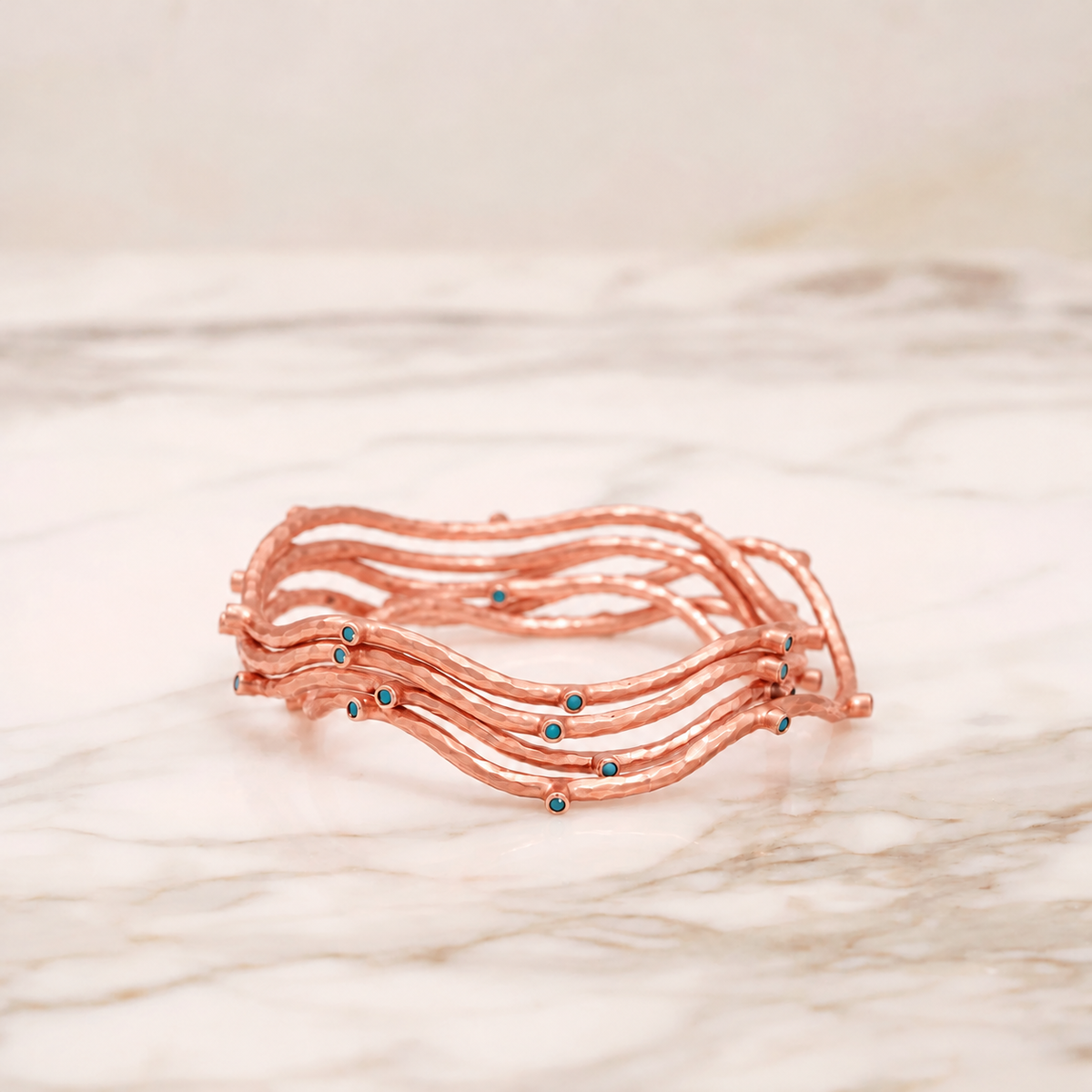 SET OF FIVE ROSE GOLD VERMEIL BLUE PASTE BANGLES, EDITED ILLUSTRATION