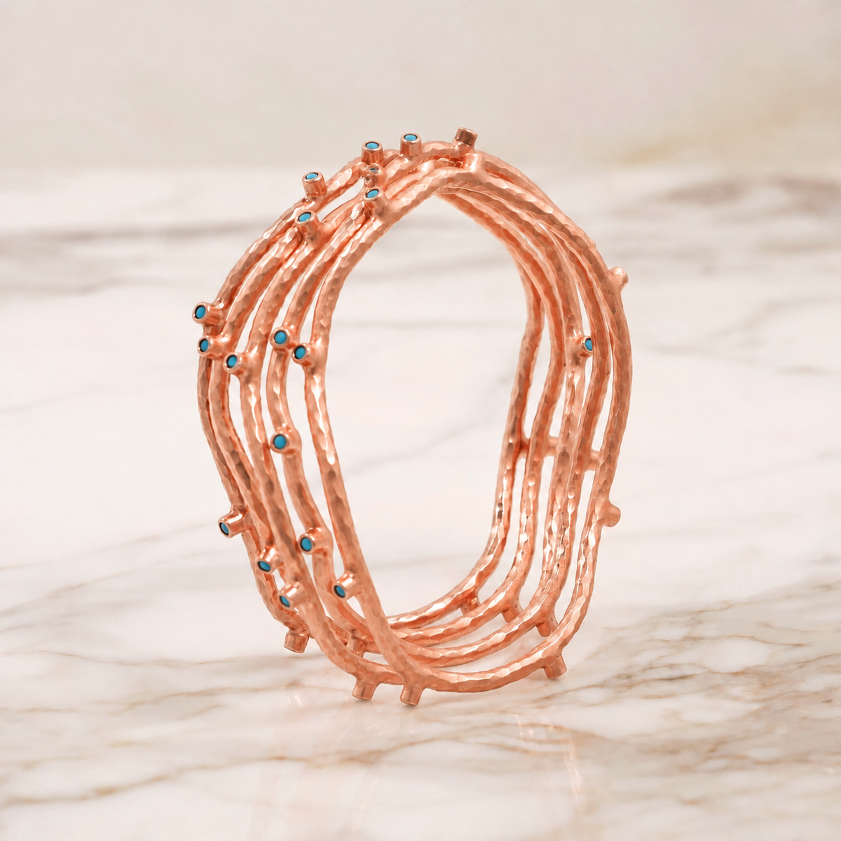 SET OF FIVE ROSE GOLD VERMEIL BLUE PASTE BANGLES, EDITED ILLUSTRATION