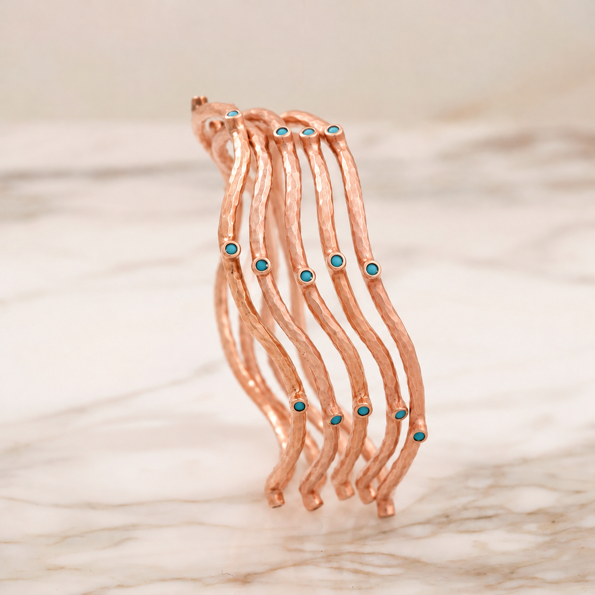 SET OF FIVE ROSE GOLD VERMEIL BLUE PASTE BANGLES, EDITED ILLUSTRATION