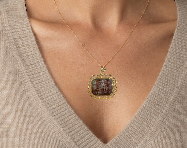 19TH CENTURY OTTOMAN CALLIGRAPHIC INTAGLIO PENDANT IN SILVER GILT — worn view