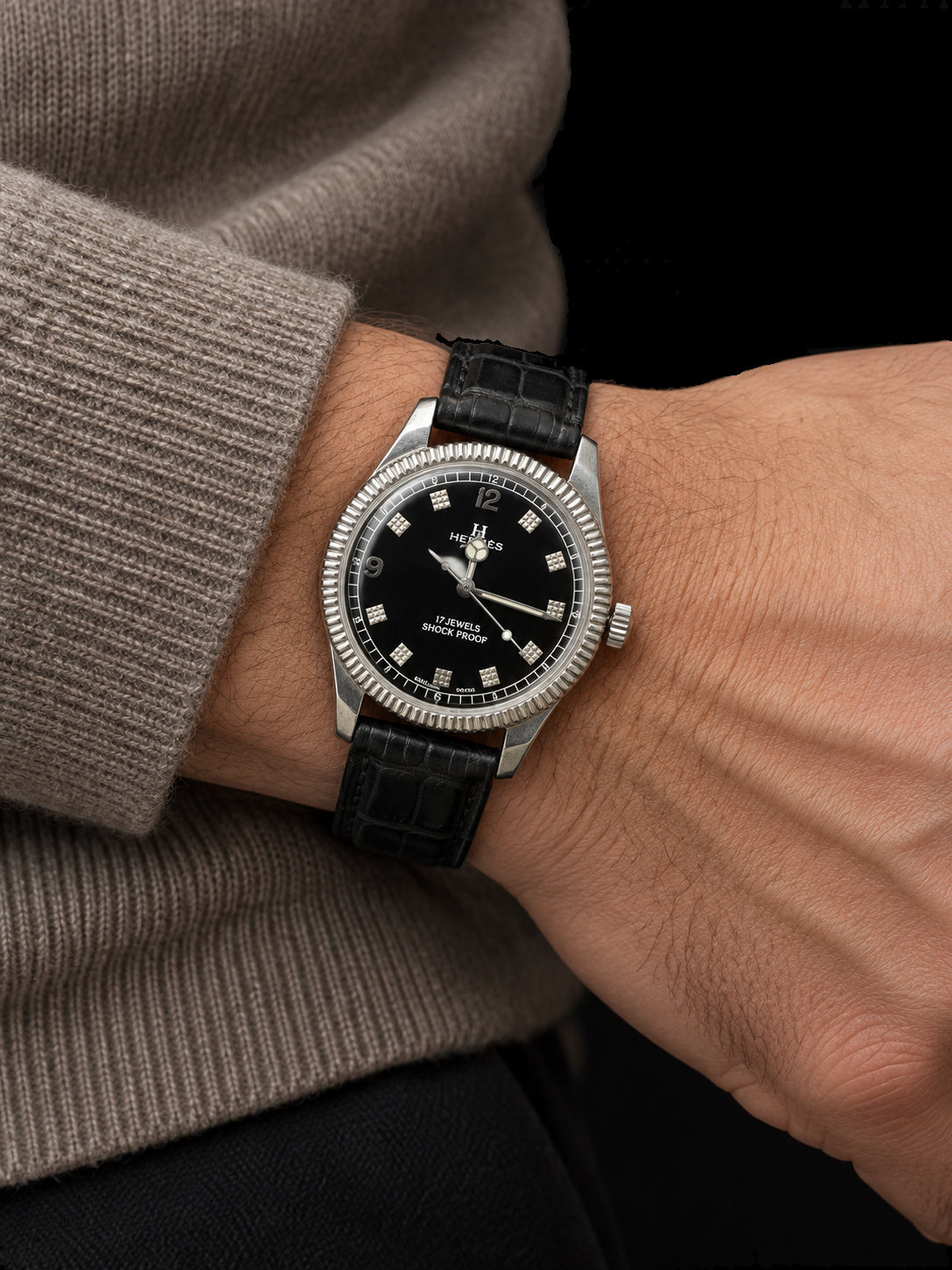 VINTAGE WATCH WITH HERMÈS SIGNED BLACK DIAL AND TEXTURED MARKERS — worn view