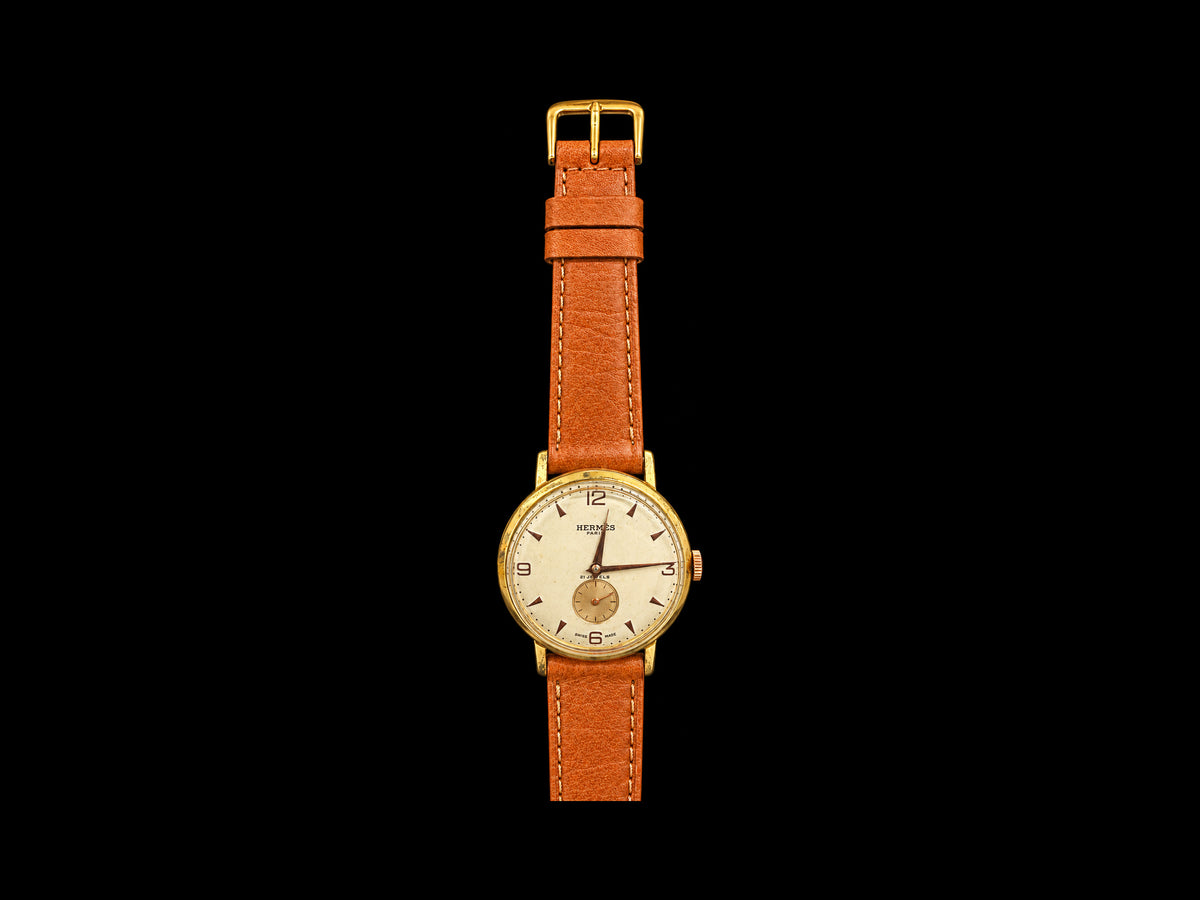 VINTAGE WATCH WITH HERMÈS SIGNED CREAM DIAL AND COGNAC STRAP — front view