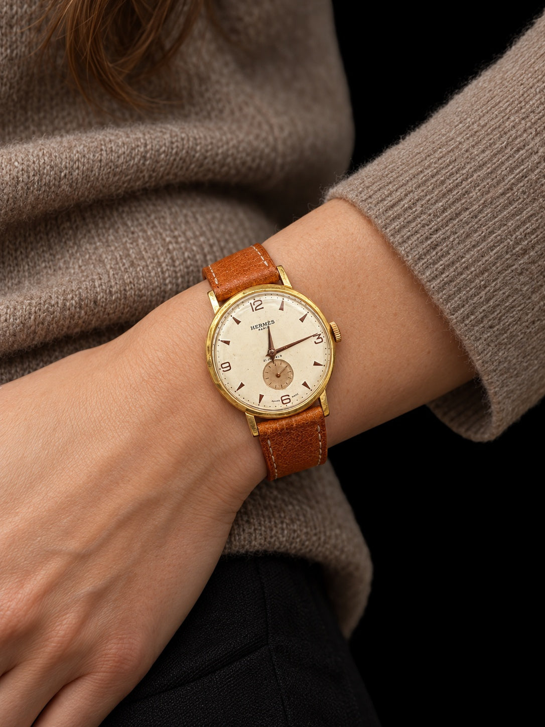 VINTAGE WATCH WITH HERMÈS SIGNED CREAM DIAL AND COGNAC STRAP — worn view