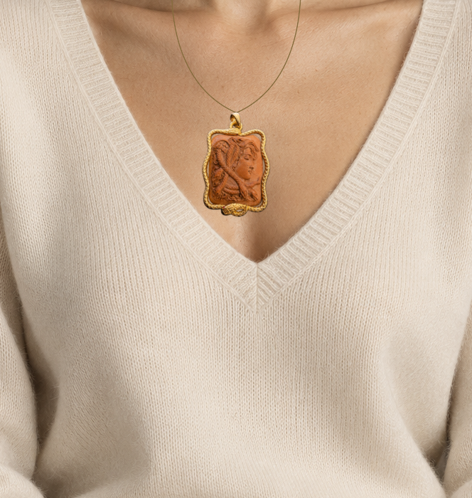 Illustrative close wearing detail of 19th century carved lava cameo in 14k gold serpent frame by sean mcnanney. Original photographed jewelry preserved; scale approximate.