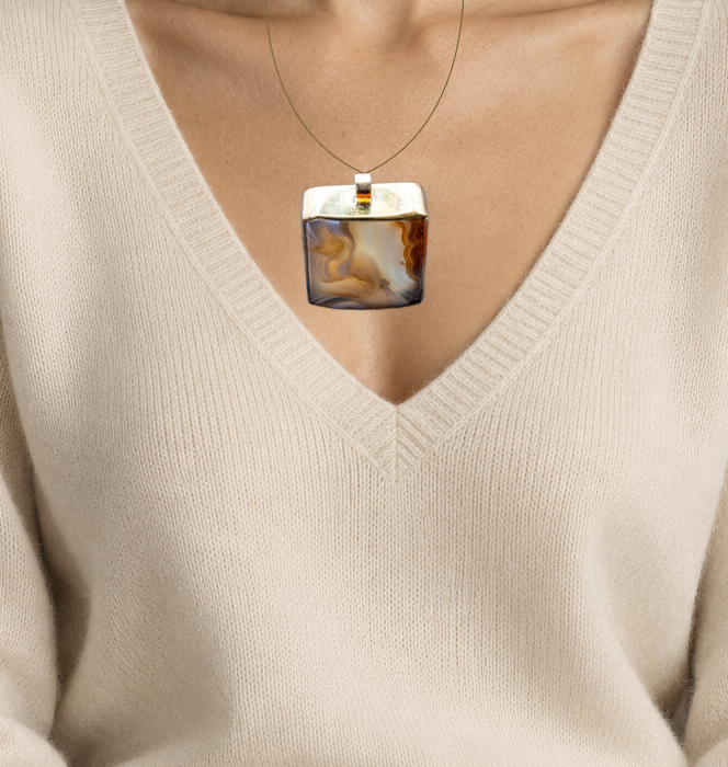 Illustrative close wearing detail of mid century scottish agate pendant in 14k gold. Original photographed jewelry preserved; scale approximate.