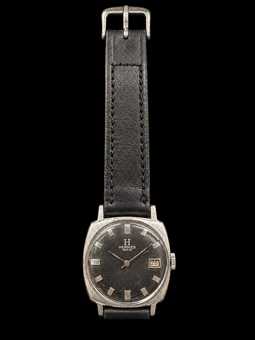 VINTAGE WATCH WITH HERMÈS SIGNED BLACK DIAL AND DATE ON BLACK BACKGROUND