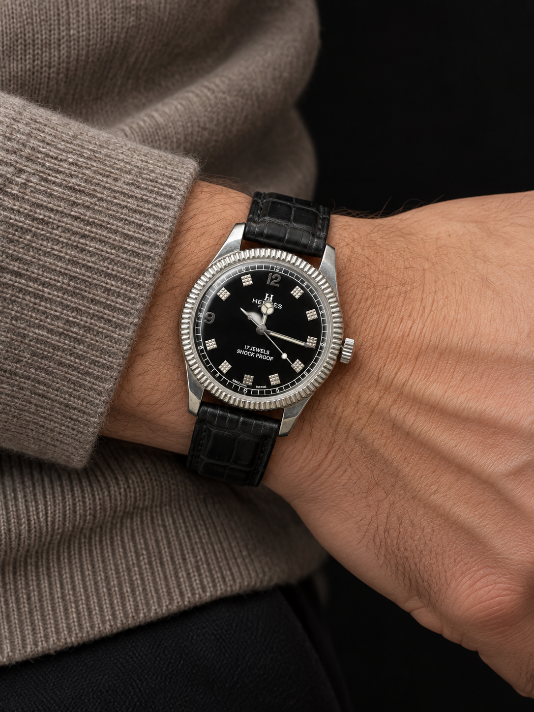 ILLUSTRATIVE MODEL STYLING WITH VINTAGE WATCH WITH HERMÈS SIGNED BLACK DIAL AND TEXTURED MARKERS AND CASHMERE