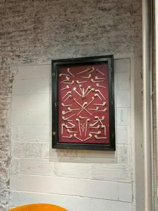 Collection of 18th and 19th century Clay Pipes in a Fitted Glass Front Cabinet