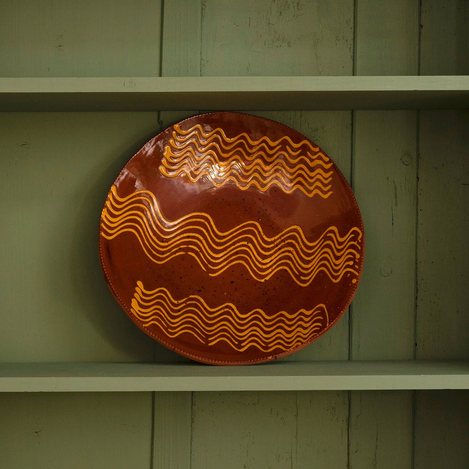REDWARE PLATE WITH STYLIZED WAVE PATTERN