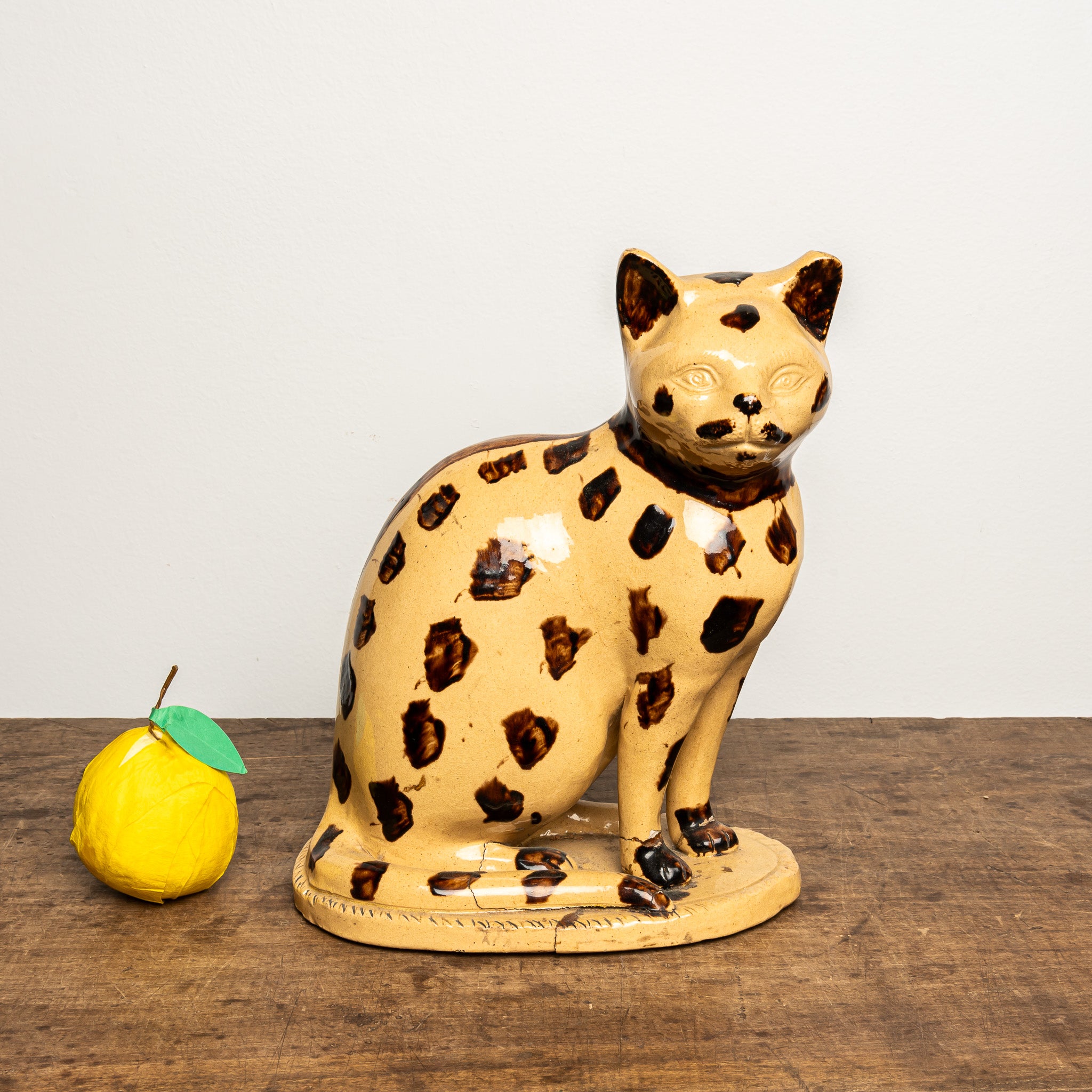 LATE 19TH-CENTURY ENGLISH STAFFORDSHIRE-STYLE GLAZED EARTHENWARE LEOPARD CAT FIGURE