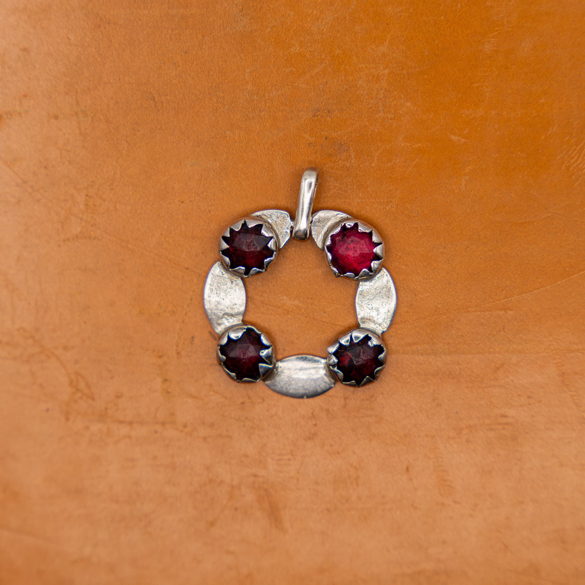 GEORGIAN ENGLISH SILVER AND FOIL-BACKED GARNET PENDANT, CONVERTED FROM A BUCKLE