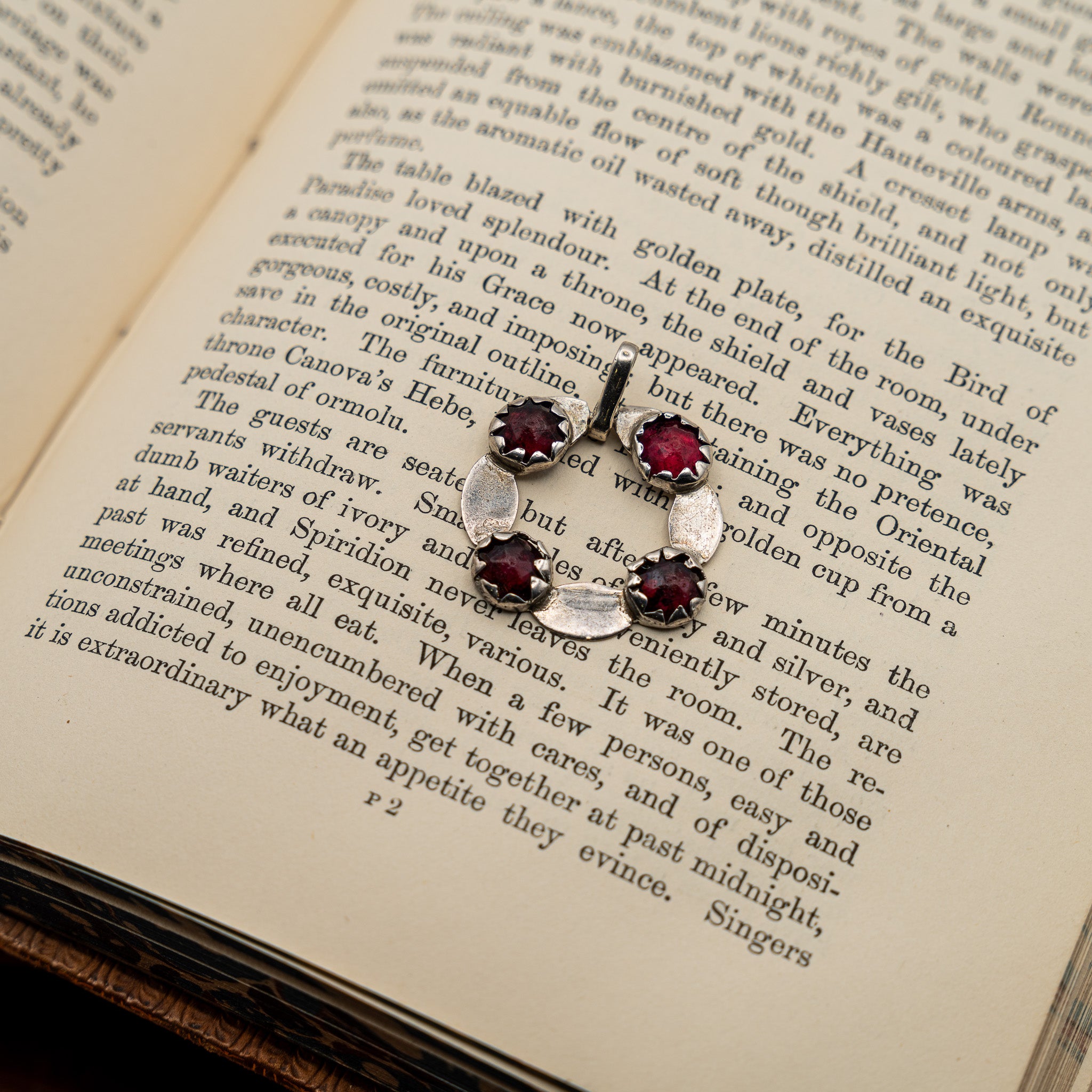 GEORGIAN ENGLISH SILVER AND FOIL-BACKED GARNET PENDANT, CONVERTED FROM A BUCKLE