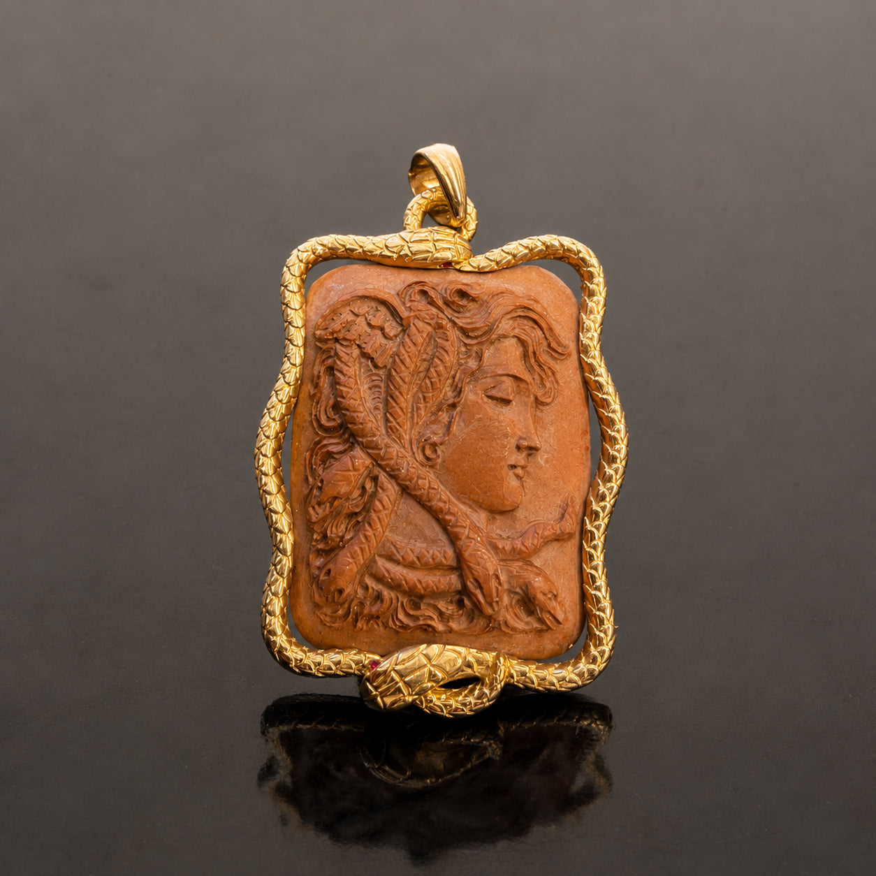 19TH-CENTURY CARVED LAVA CAMEO IN 14K GOLD SERPENT FRAME BY SEAN McNANNEY