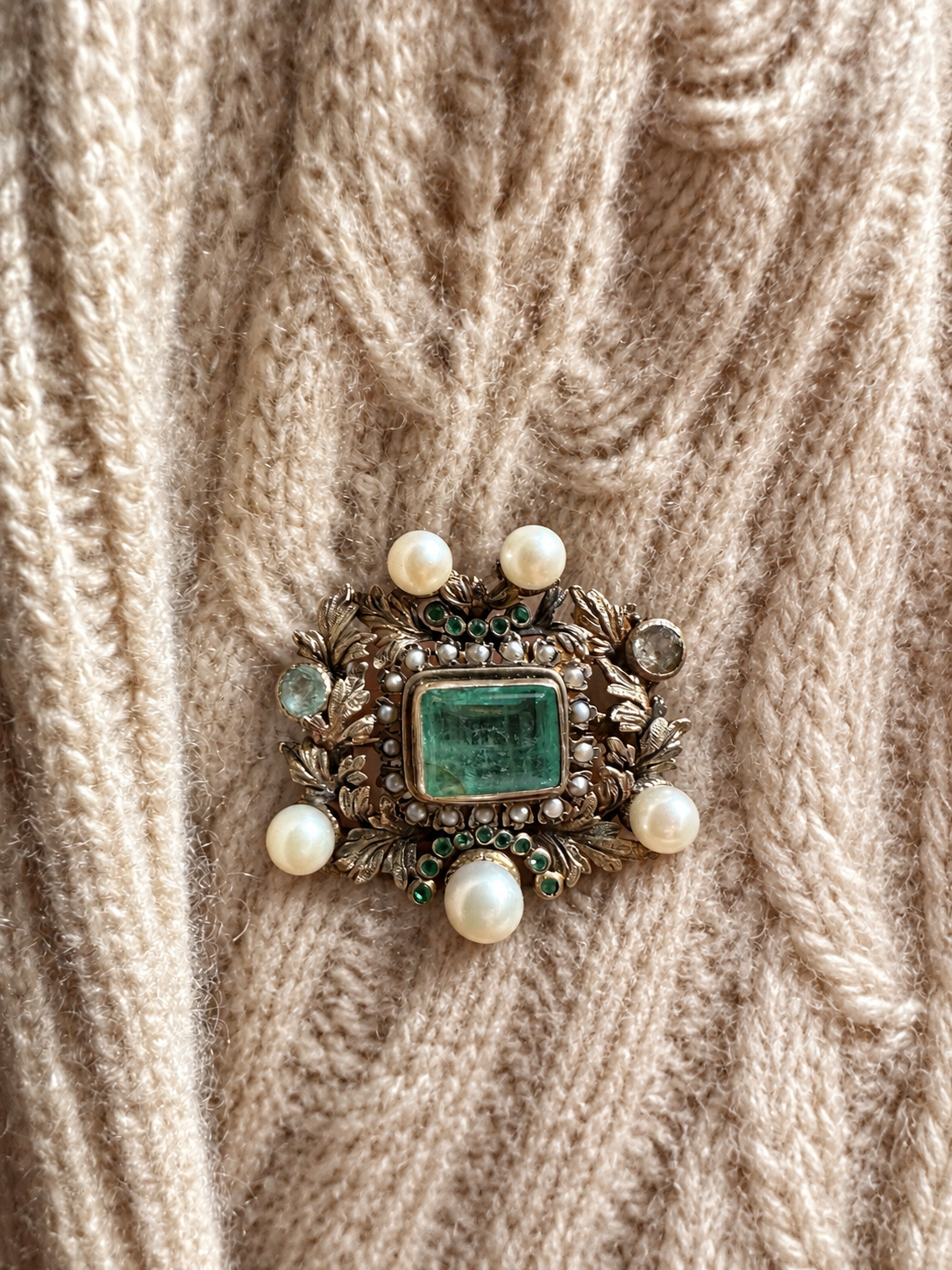 Brooch styled on cream cashmere