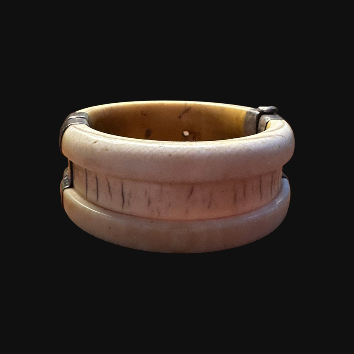 Raised rims and aged surface of bone bracelet