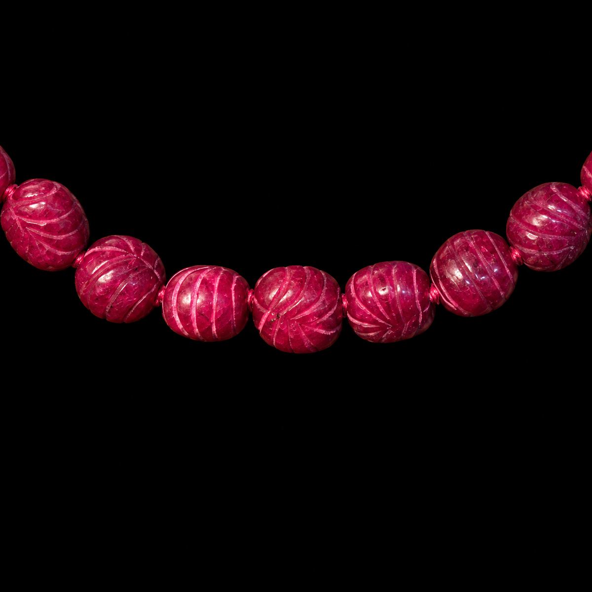 MUGHAL INSPIRED CARVED RUBY COLORED STONE NECKLACE, FRONT VIEW ON BLACK