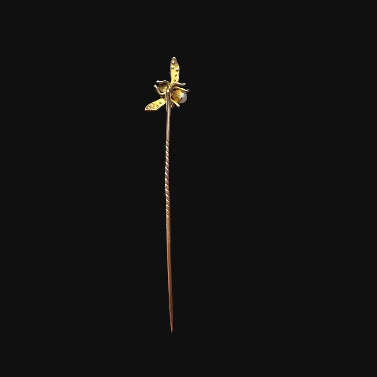 Reverse of antique English gold pearl bee stick pin on black