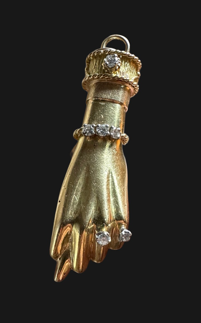 Complete front of French gold and diamond hand pin attributed to Fred Paris