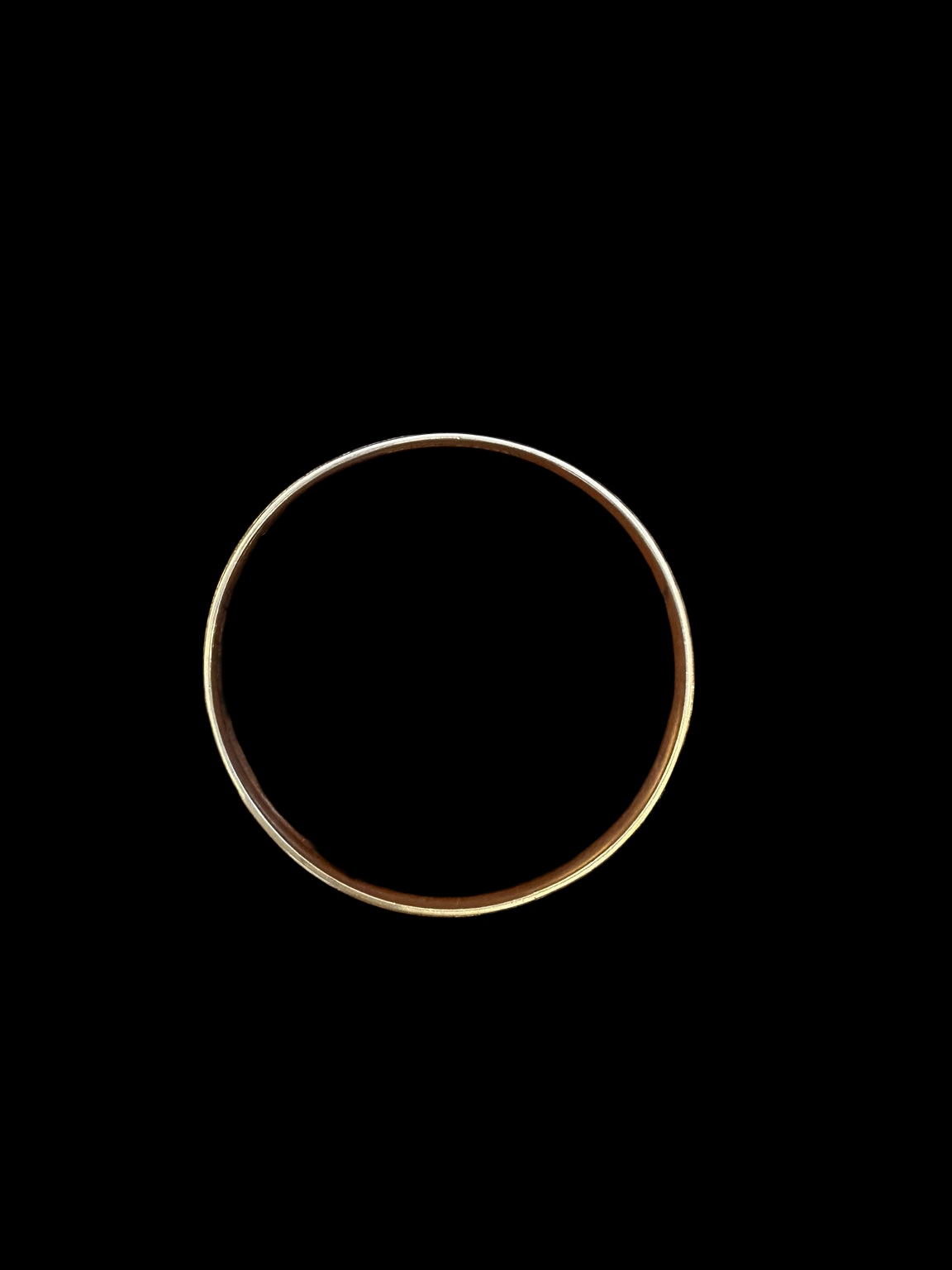 EARLY 20TH CENTURY GREEK KEY 9 KARAT GOLD CASED BANGLE on black background
