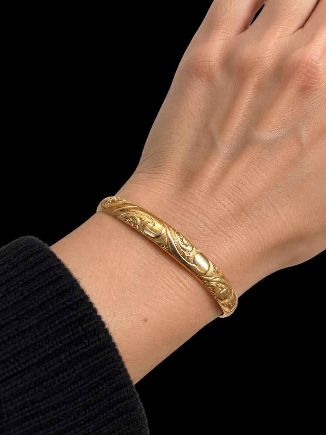 19TH CENTURY VICTORIAN ENGRAVED 12 KARAT GOLD BANGLE — worn view