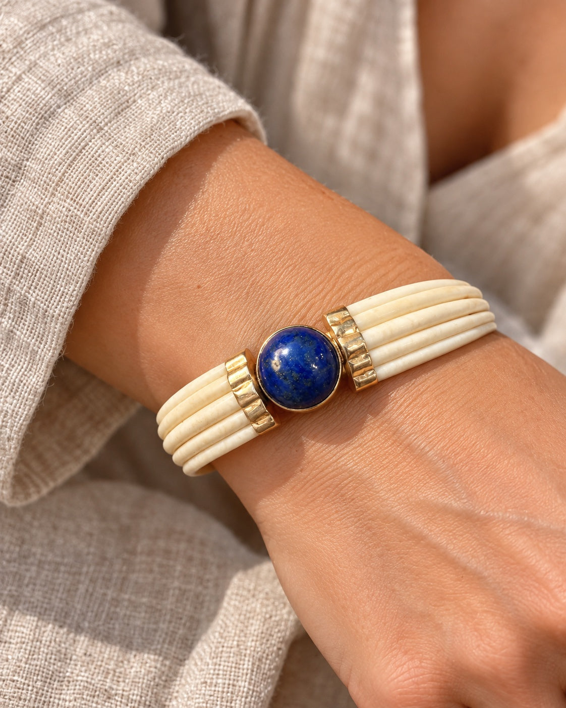 LAPIS LAZULI AND BONE BANGLE WITH 14 KARAT GOLD — worn view