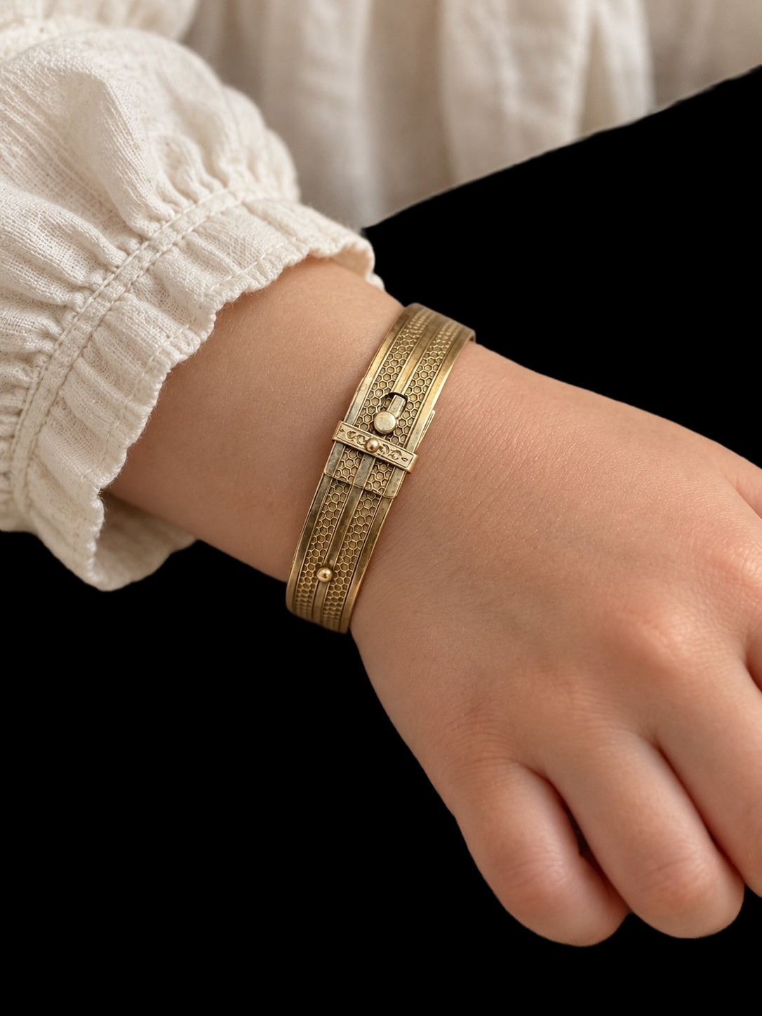 19TH CENTURY CHILD'S GOLD BUCKLE BRACELET WITH HONEYCOMB PATTERN — worn view