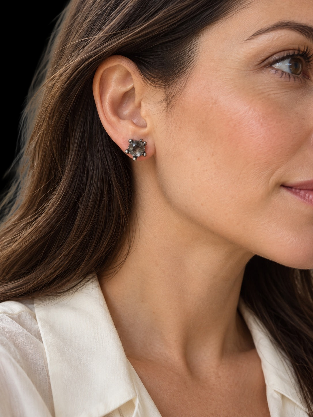 Model wearing 18TH CENTURY ROCK CRYSTAL SINGLE EARRING IN SILVER AND 14 KARAT GOLD against a black background