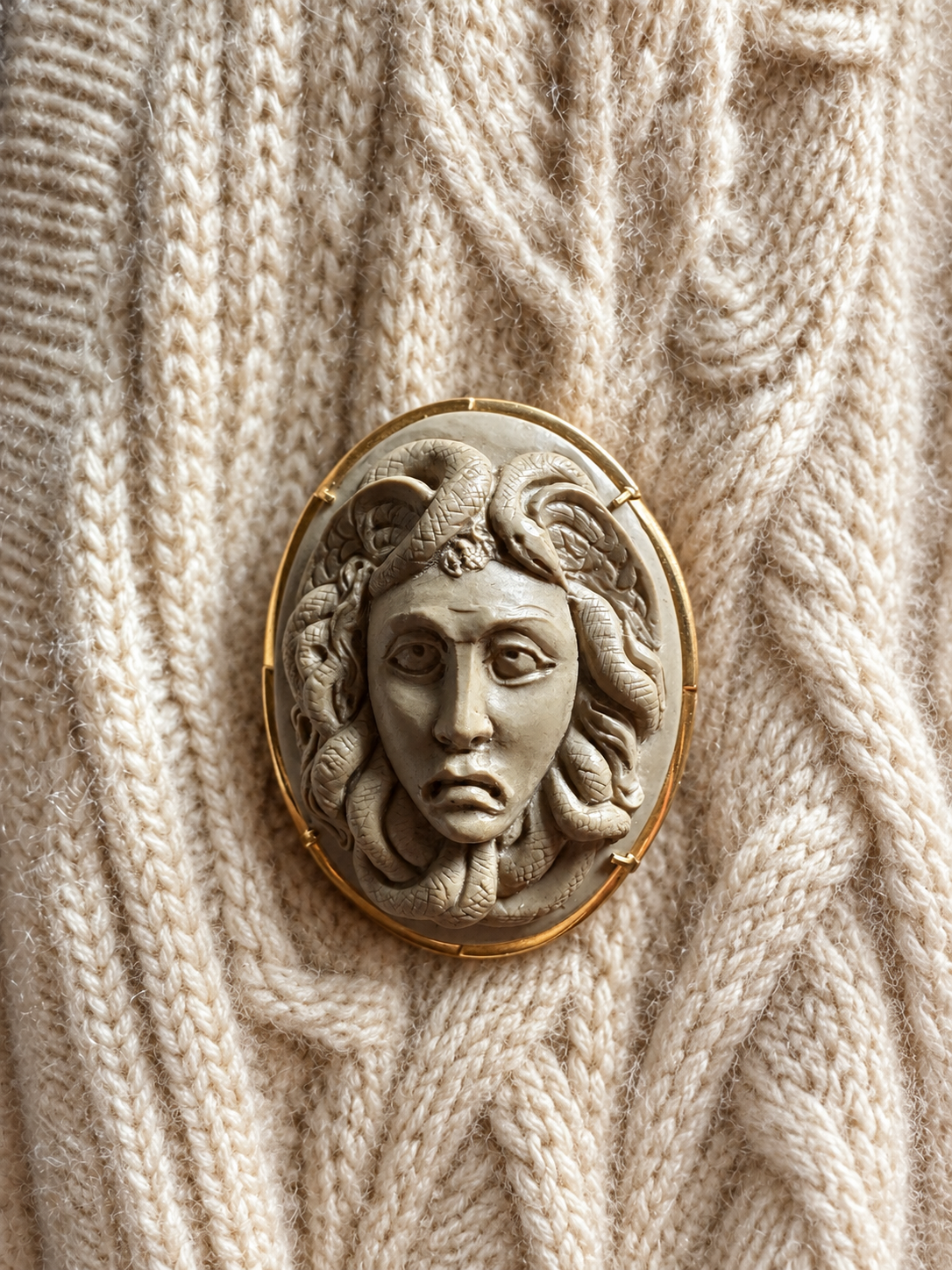 Medusa cameo styled on cream cashmere