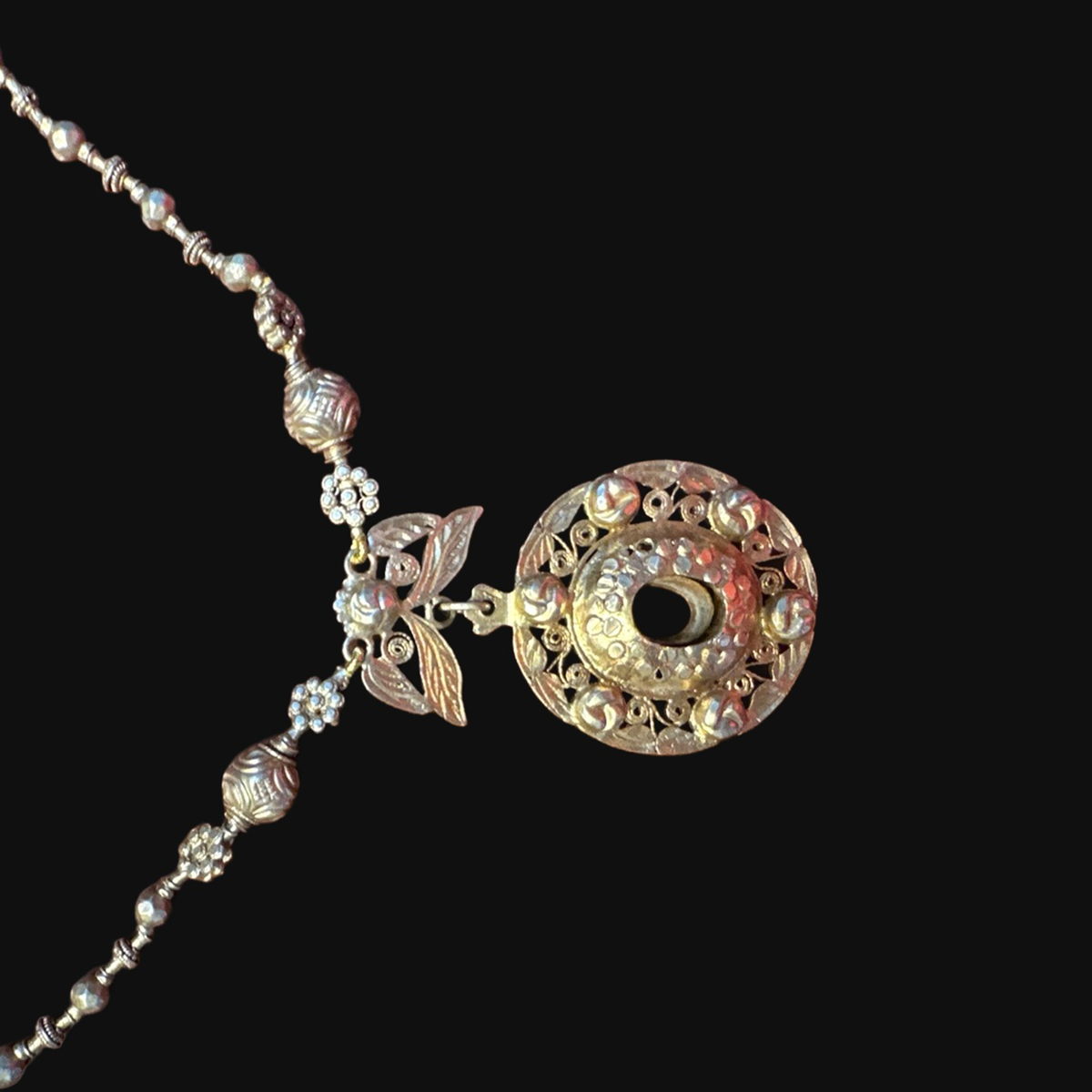 Actual silver-gilt reliquary pendant with pierced decoration and leafy connector