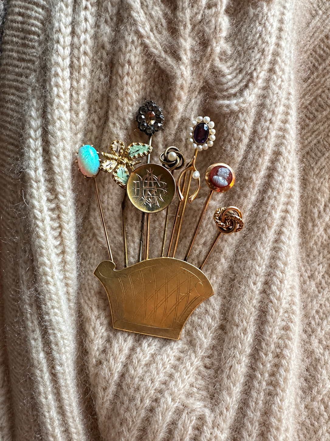 Stick-pin assemblage brooch styled on cream cashmere