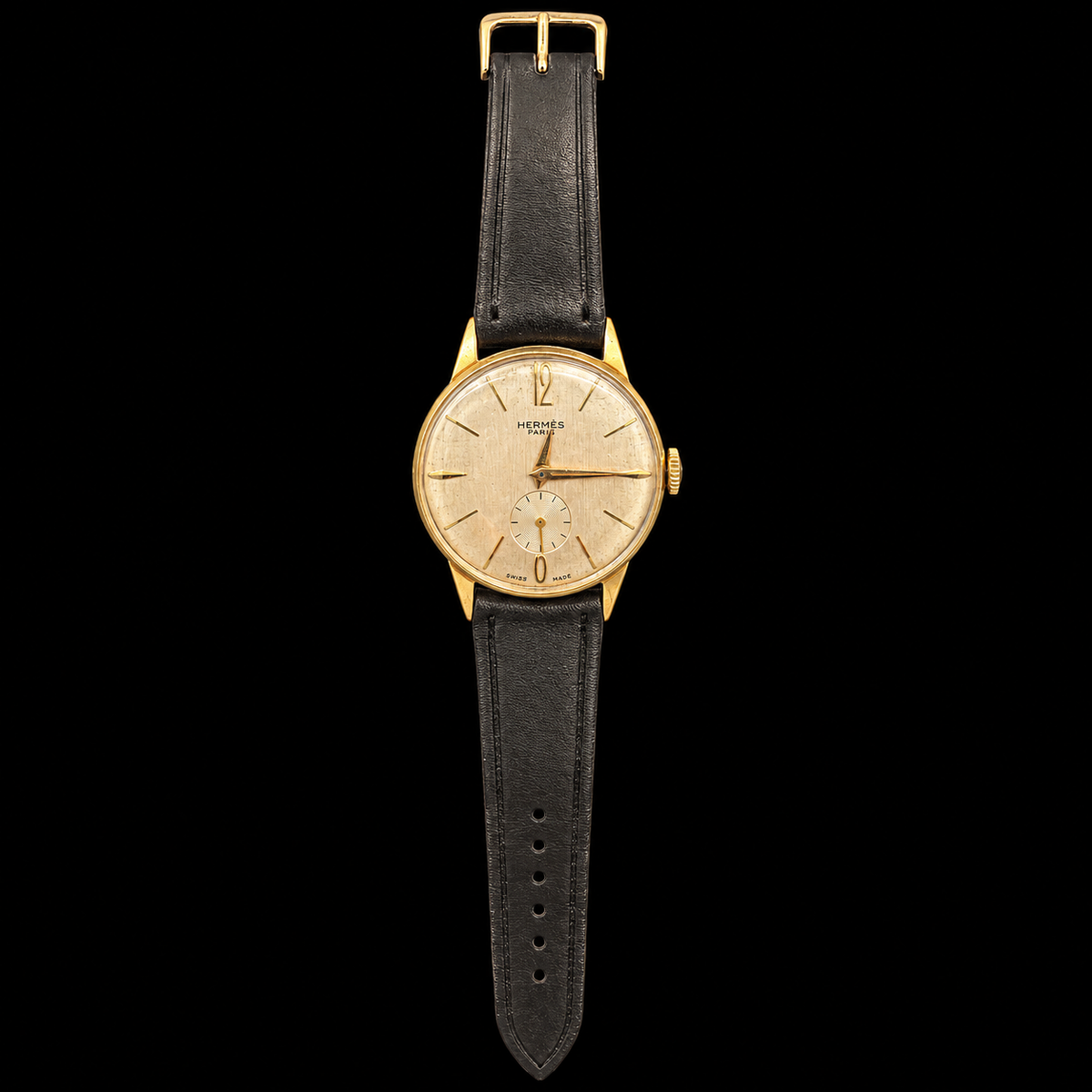 VINTAGE GOLD PLATED WATCH WITH HERMÈS SIGNED DIAL ON BLACK BACKGROUND