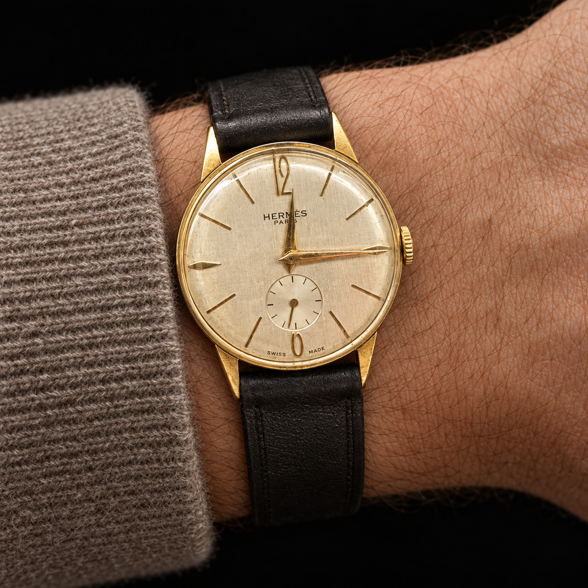 ILLUSTRATIVE MODEL STYLING WITH VINTAGE GOLD PLATED WATCH WITH HERMÈS SIGNED DIAL AND CASHMERE