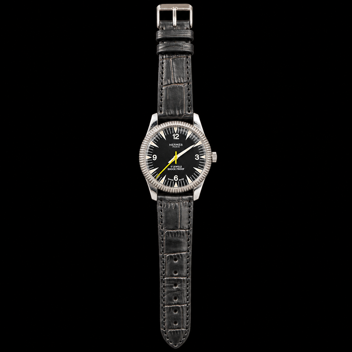 VINTAGE WATCH WITH HERMÈS SIGNED BLACK DIAL ON BLACK BACKGROUND