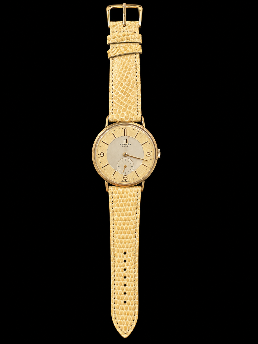 VINTAGE WATCH WITH HERMÈS SIGNED TWO TONE DIAL AND LIZARD STRAP ON BLACK BACKGROUND